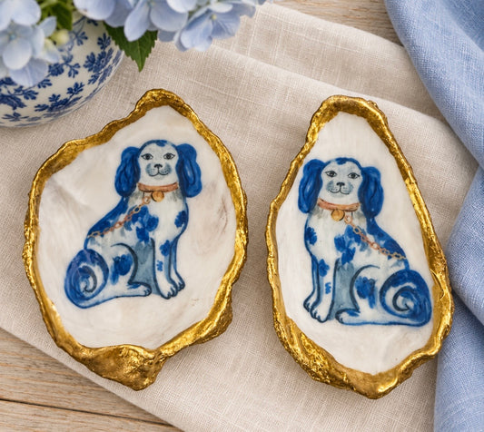 Facing pair of blue and white Staffordshire dog oyster shells with gold-painted edges