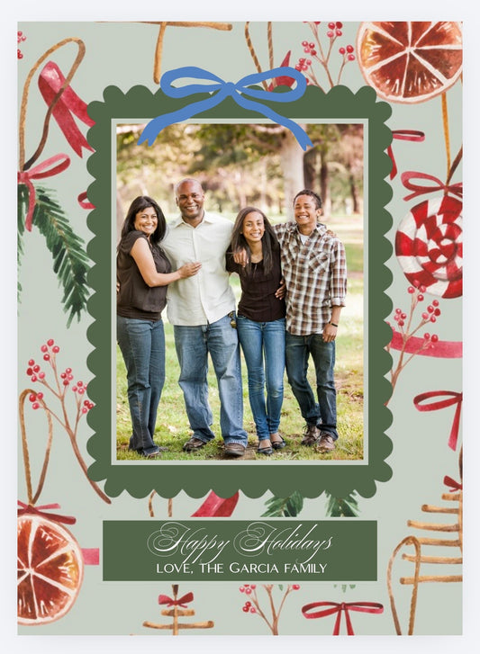 Photo Christmas card with citrus slices, red ribbons, evergreen sprigs, green scalloped frame and blue bow
