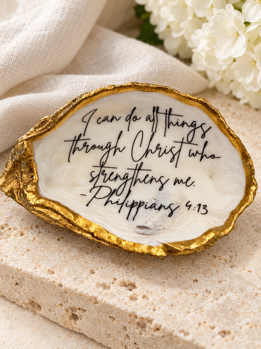 Gold-edged oyster featuring Philippians 4:13, staged with ivory linen and white hydrangeas